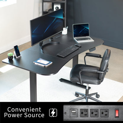 63” x 32” Electric Height Adjustable Stand Up Desk in Modern Office Space. Features a built-in power strip.