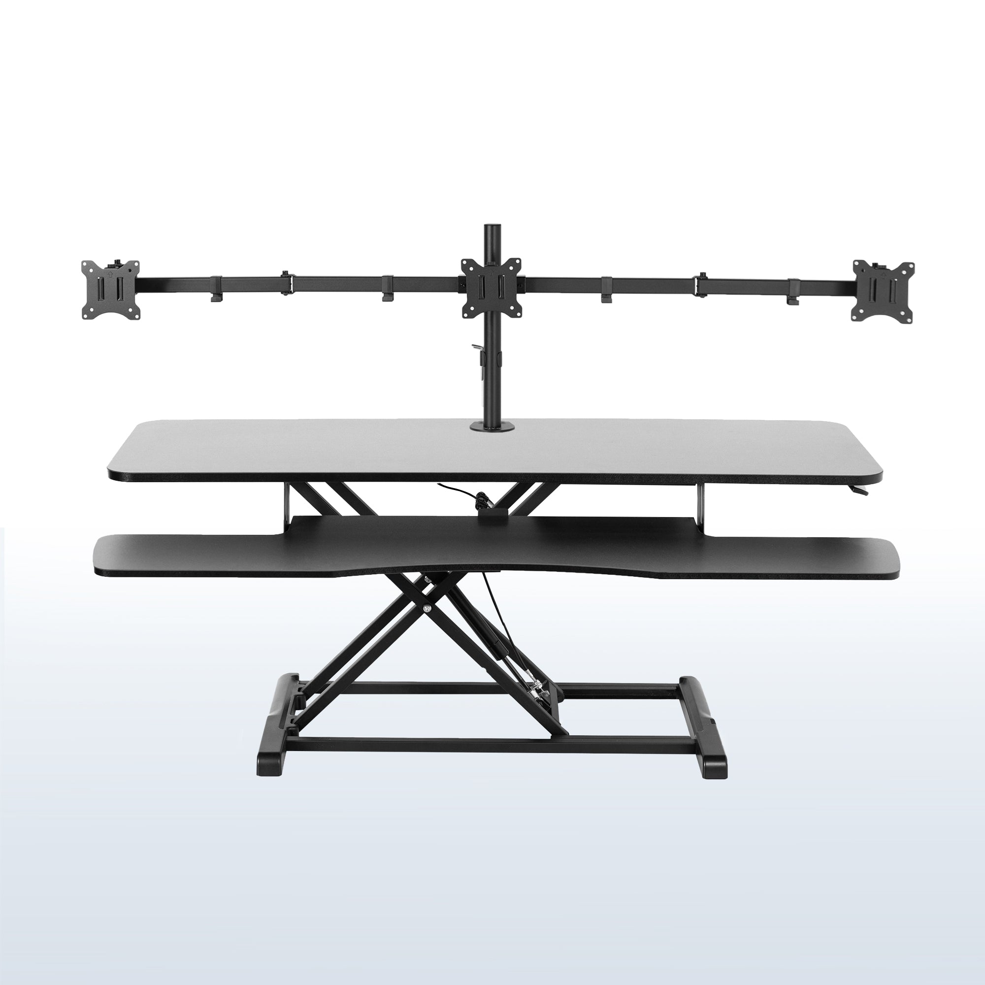 Spacious height adjustable desk riser with articulating triple monitor mount.