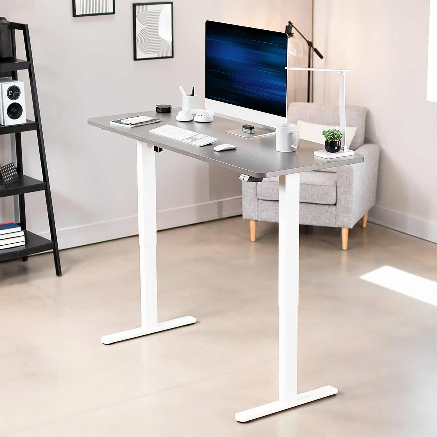 Modern office setup with a standing desk, computer monitor, and chair.