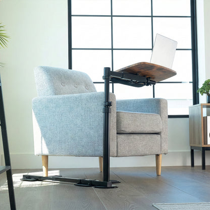 Gray armchair with a adjustable work desk in a modern room.