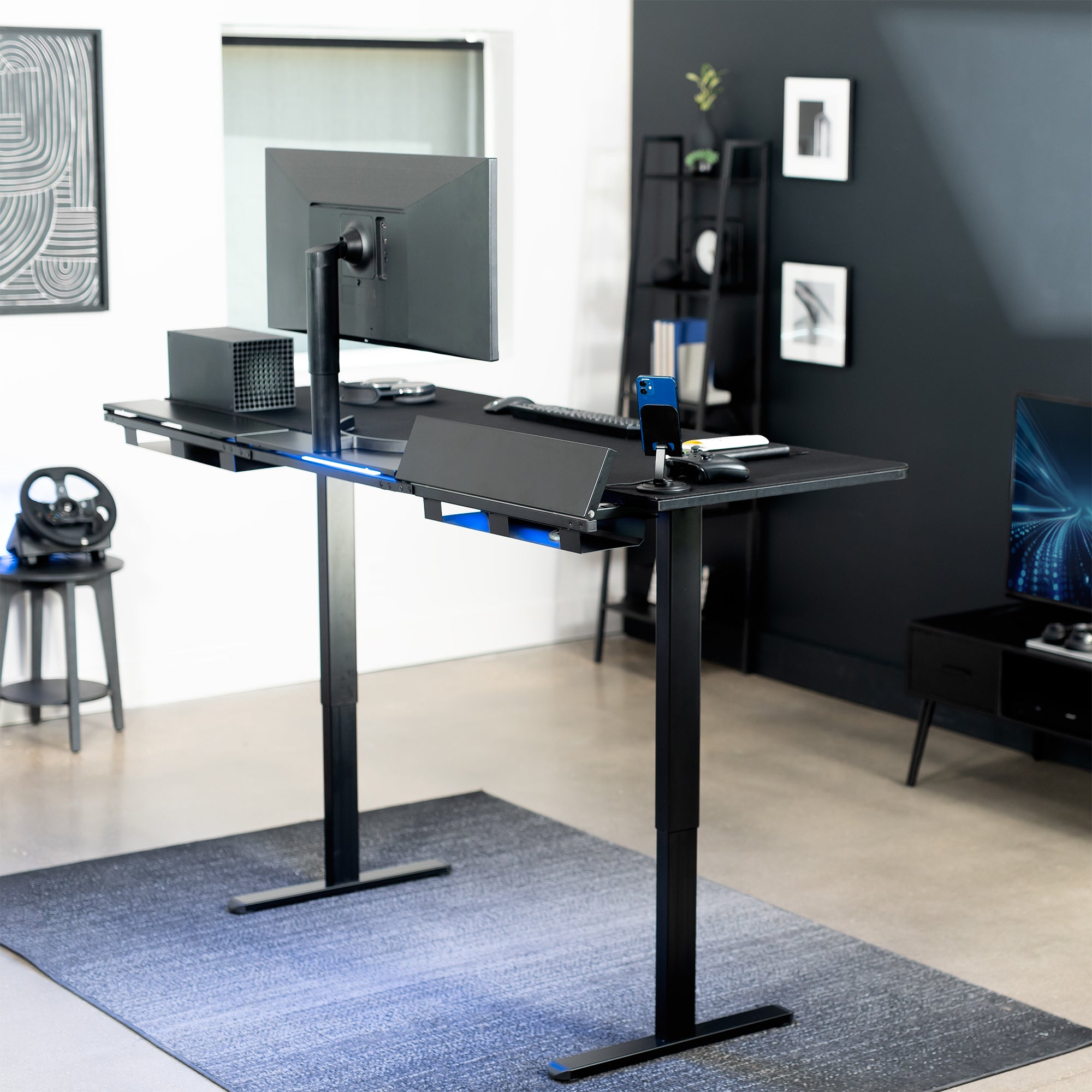 Modern office setup with a standing desk, computer monitor, and office chair.