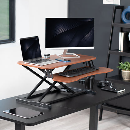 Sturdy height adjustable 2-tiered desk riser for ergonomic office workstation.