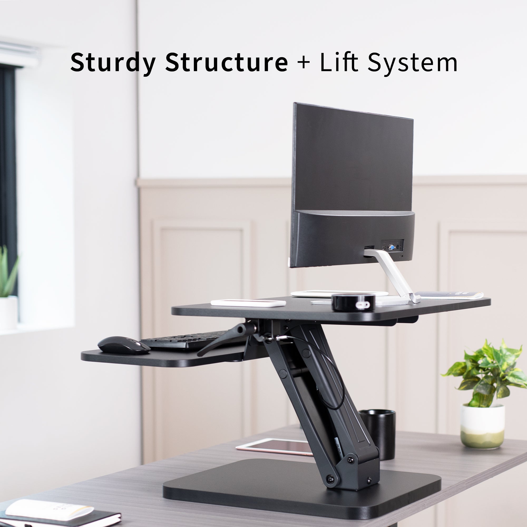 Sit stand desk converter sits on top of current desk and raises and lowers for a comfortable viewing and typing experience.