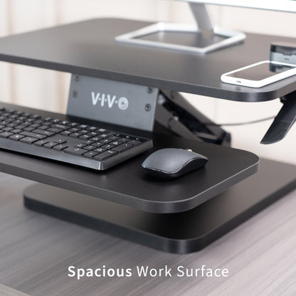 Sit stand desk converter sits on top of current desk and raises and lowers for a comfortable viewing and typing experience.