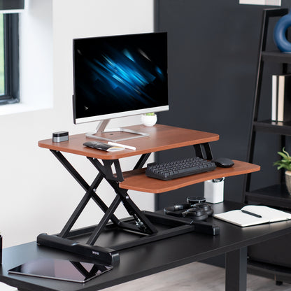 Sturdy height adjustable 2-tiered desk riser for ergonomic office workstation.