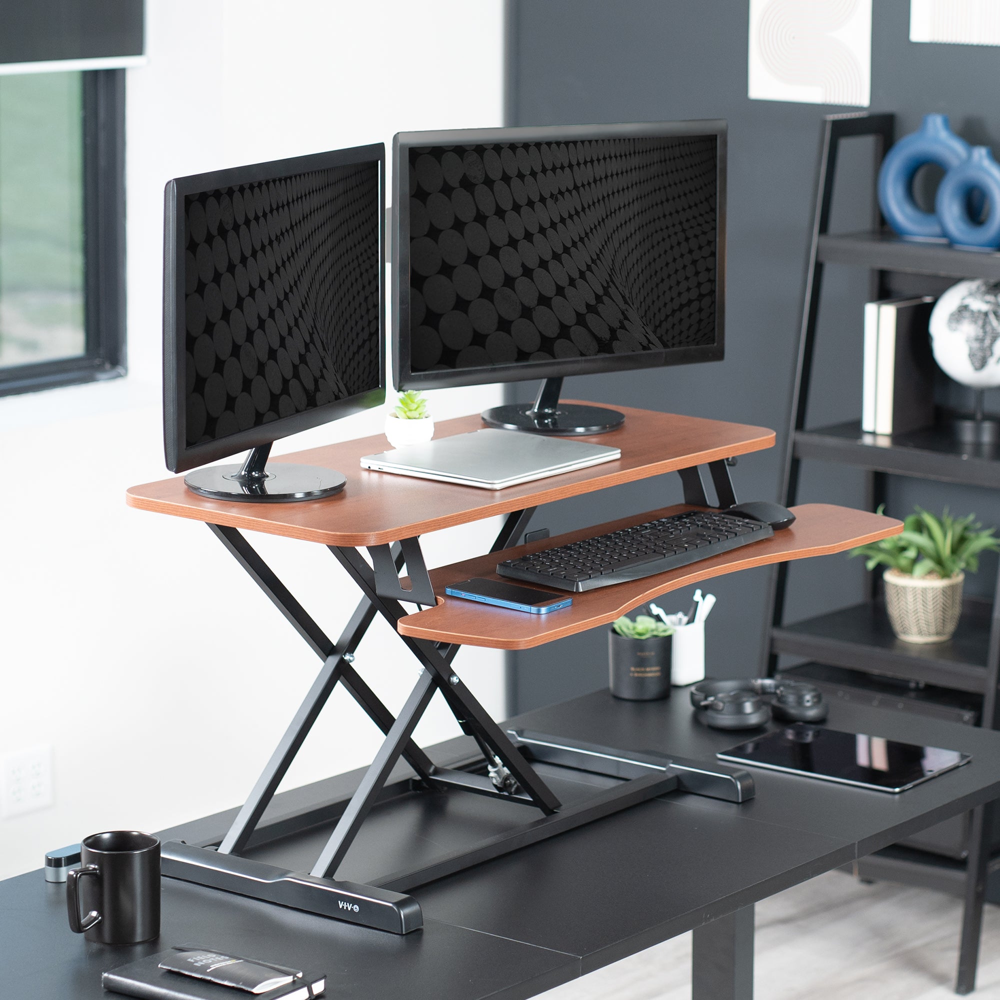 Sturdy height adjustable 2-tiered desk riser for ergonomic office workstation.