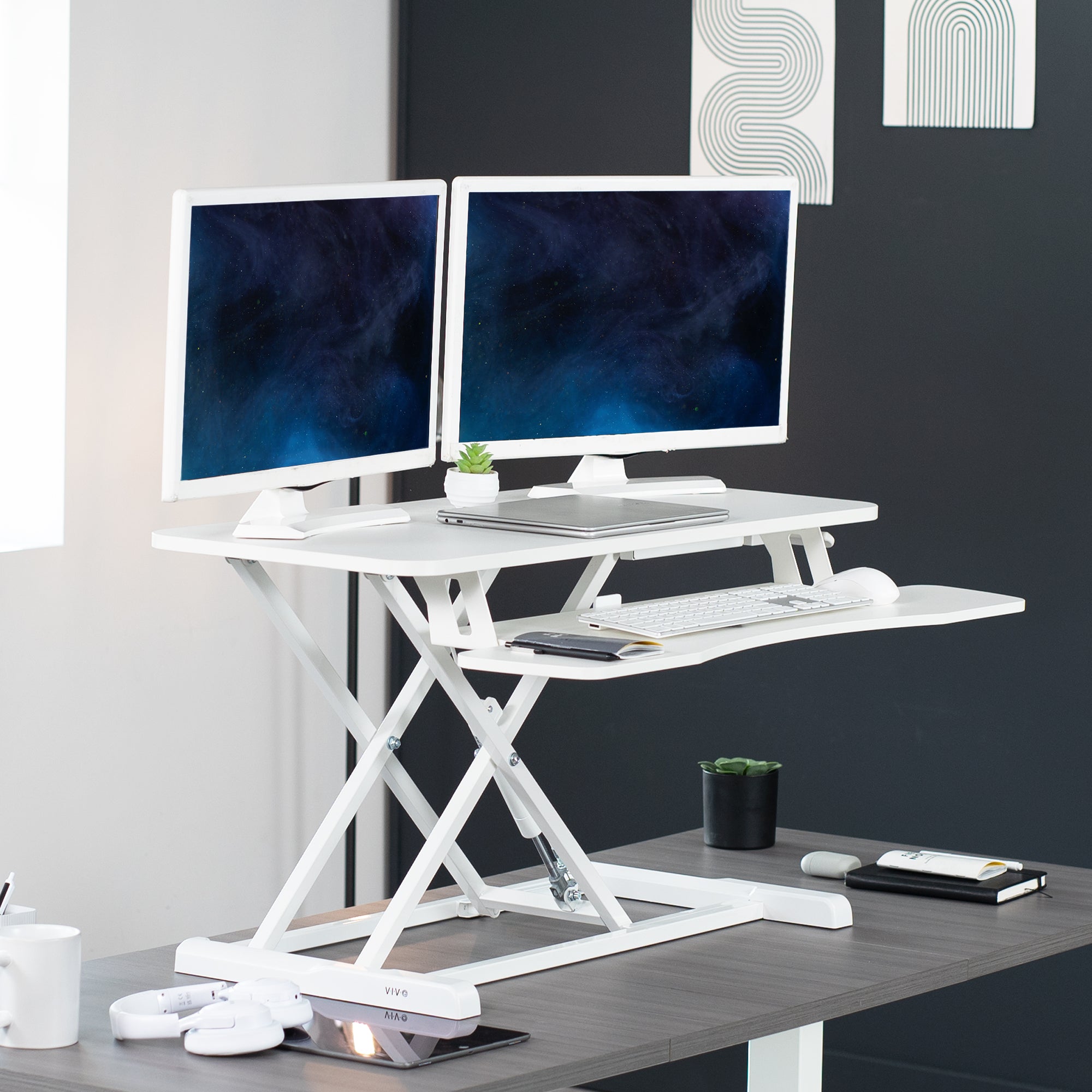 Sturdy height adjustable 2-tiered desk riser for ergonomic office workstation.