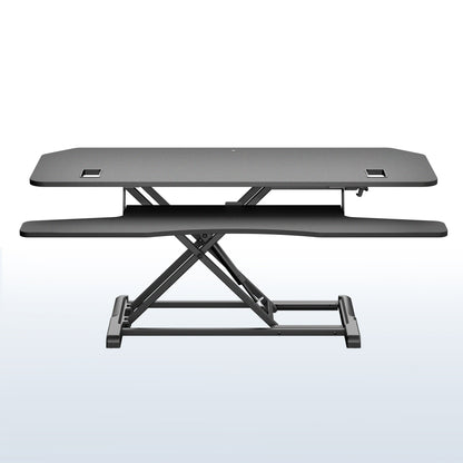 A black adjustable standing desk with a dual-tier design, featuring a raised desktop and a lower shelf supported by a robust scissor-style metal base, shown against a light white and blue gradient background.