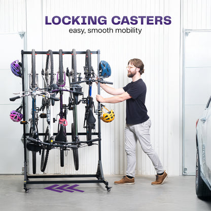 Person using a bike rack with locking casters in a garage setting.