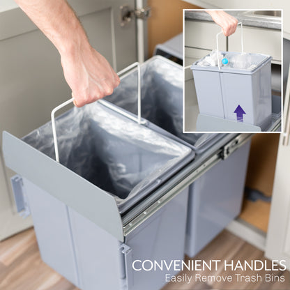 An under-counter dual trash can system with silver containers and a handle showing easy removal. 