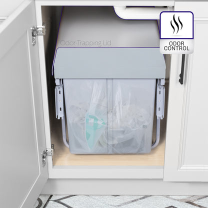An under-counter dual trash can system with silver containers with an icon showing odor control feature. 