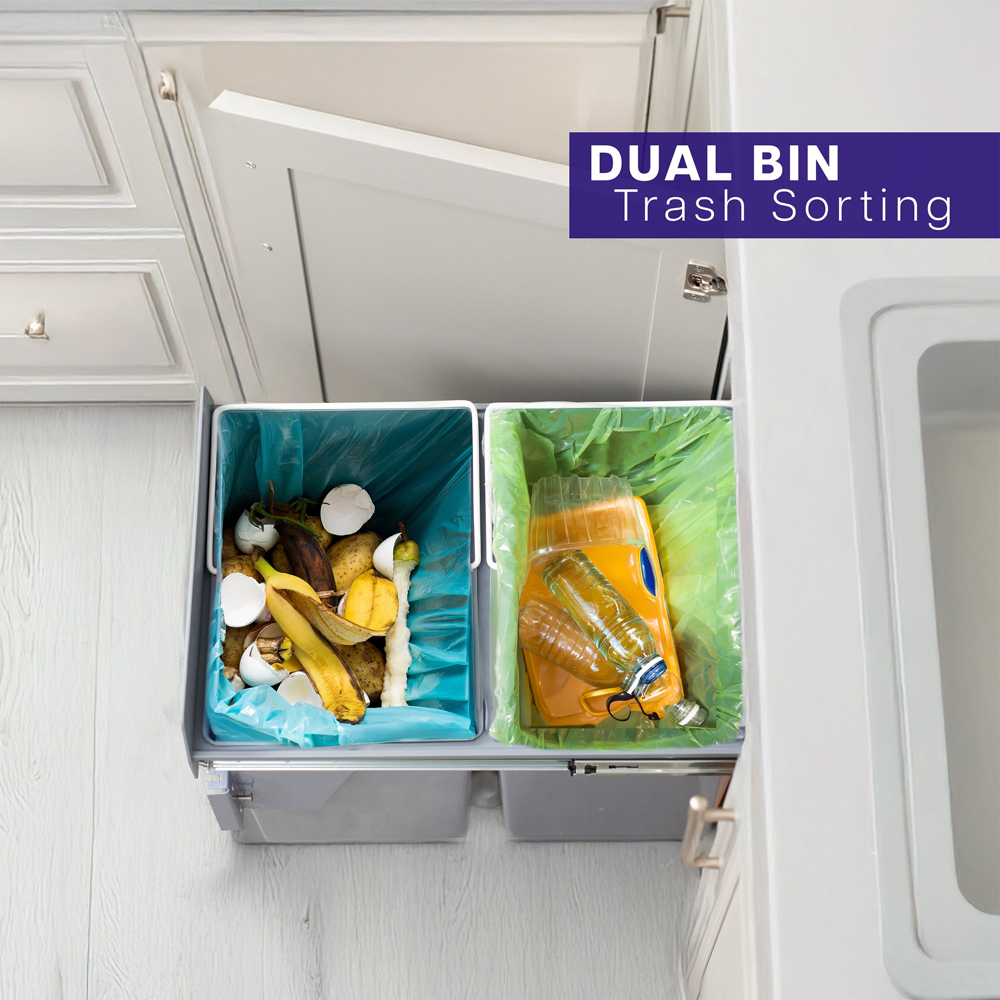 An under-counter dual trash can system with silver containers and a beige lid. 