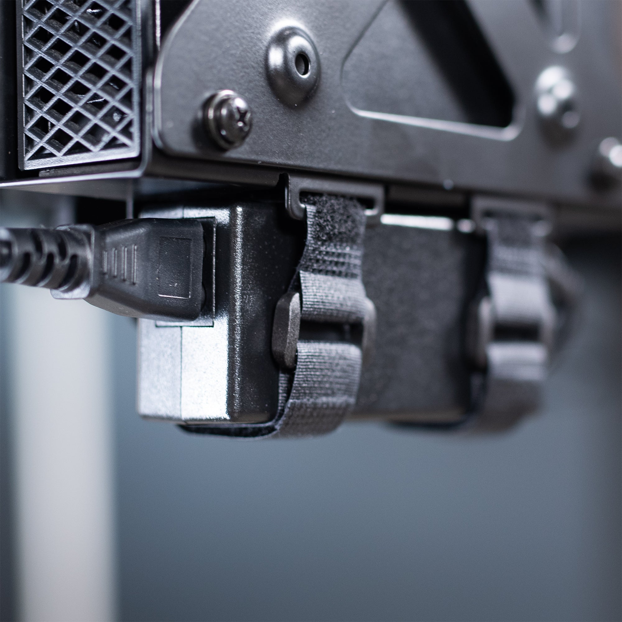 Close-up of straps on a Mount Designed for Dell OptiPlex Micro on a gray background