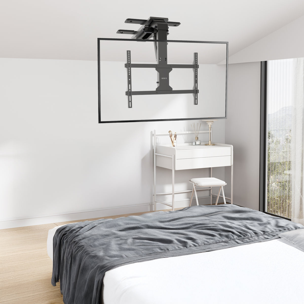 Electric Flip Down Ceiling TV Mount - 37" to 70" Screens shown on ceiling in a bedroom