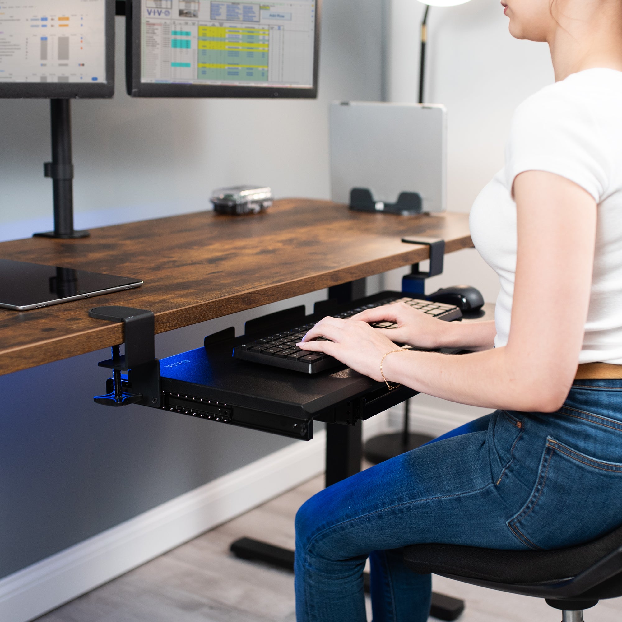 Clamp-on keyboard tray with pencil drawer for convenient space-saving desk workstation.