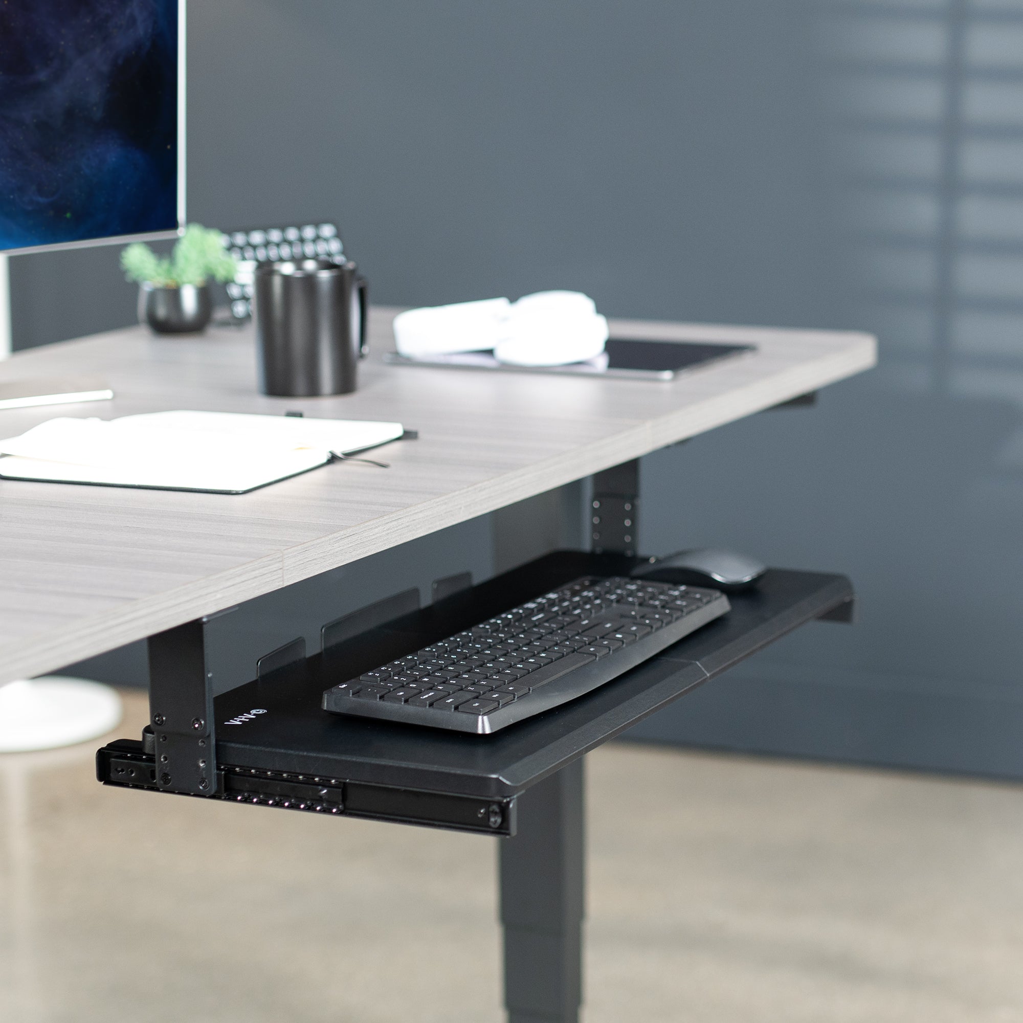 Under desk height adjustable pull-out sliding keyboard tray.