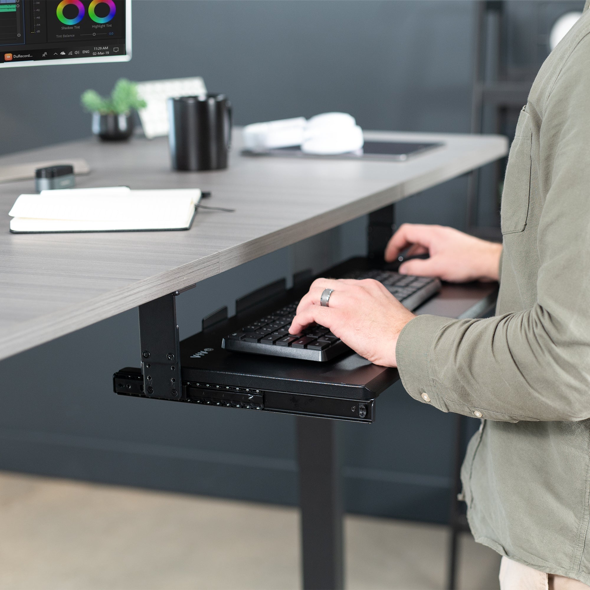 Under desk height adjustable pull-out sliding keyboard tray.