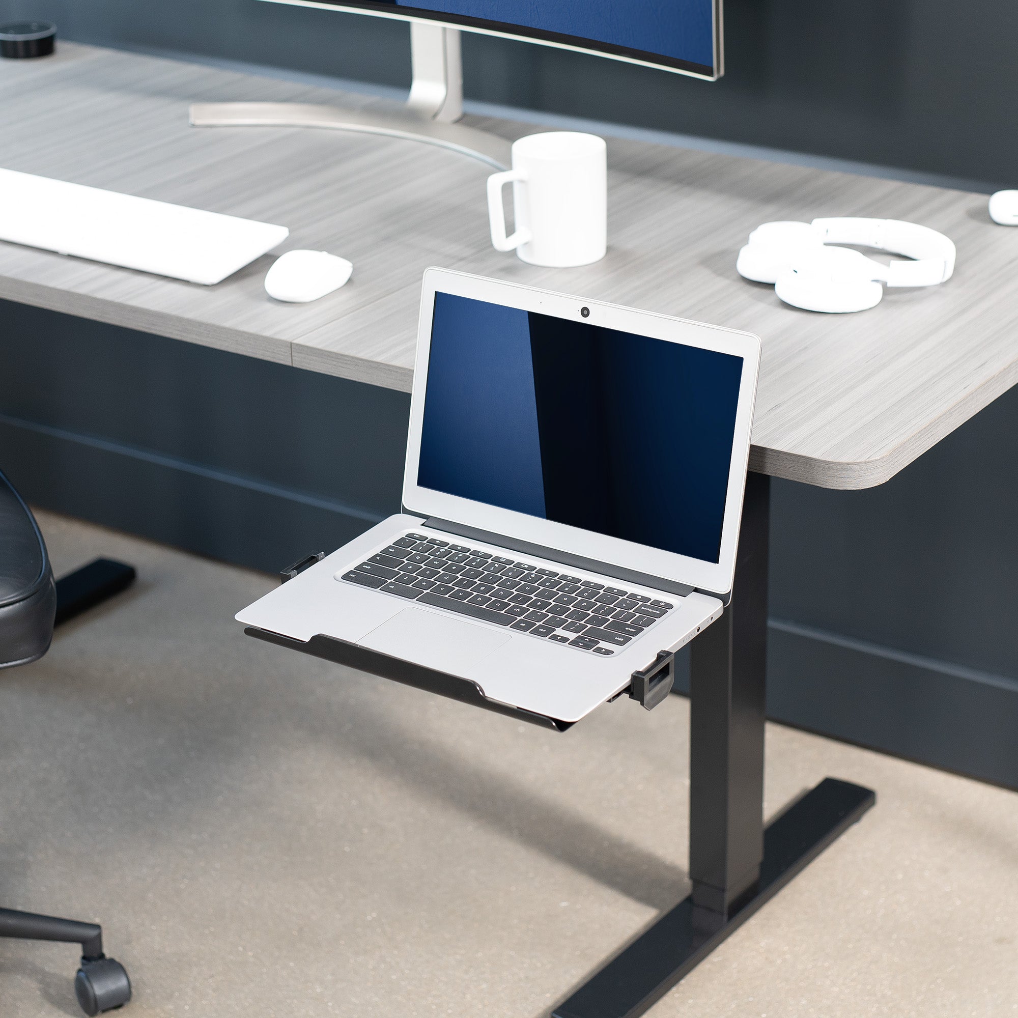 Black Single Clamp Rotating Laptop Tray for home or office use attached to desk.