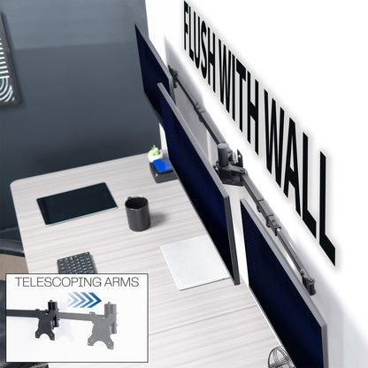 A black telescoping triple monitor wall mount that is flush against the wall. 