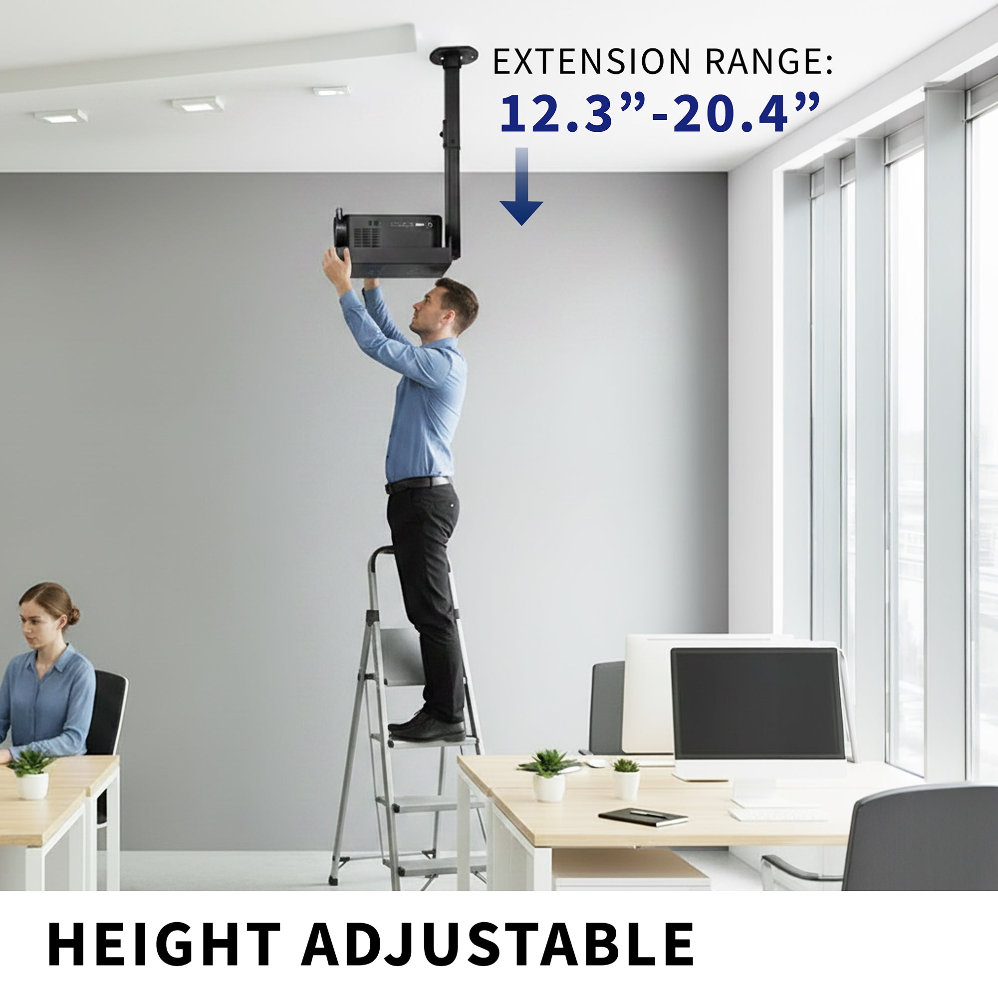 Person using a height-adjustable extension projector tray in an office setting.