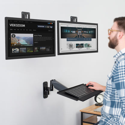 Dual monitor wall mount and height adjustable keyboard tray create a complete wall-mounted workstation.