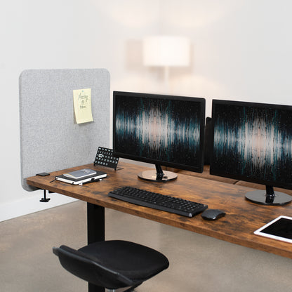 Clamp-on desk privacy panel for office workspace.