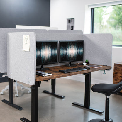 Clamp-on desk privacy panel for office workspace.