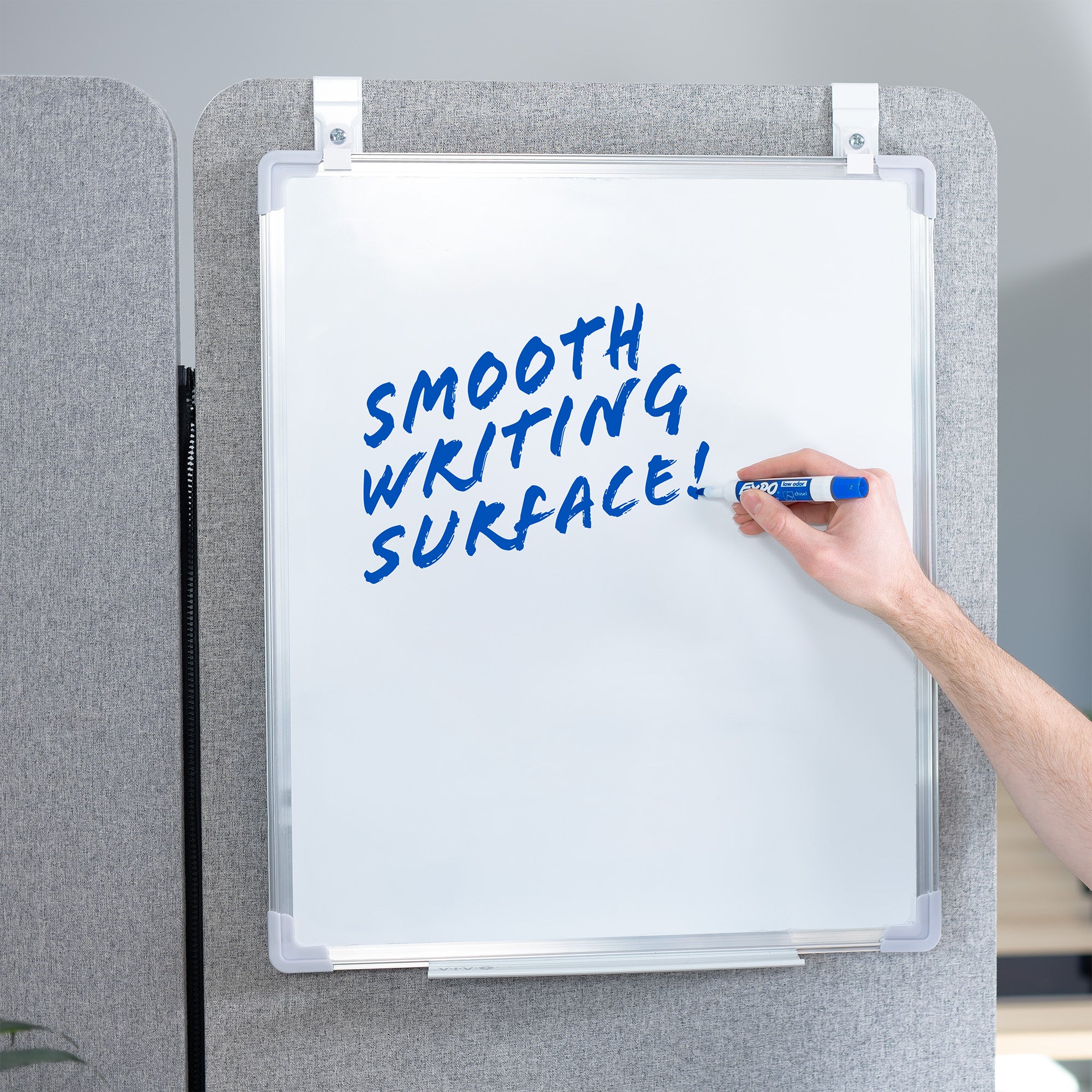 White, double-sided magnetic dry erase board mounted on a gray wall with a smooth writing surface. 