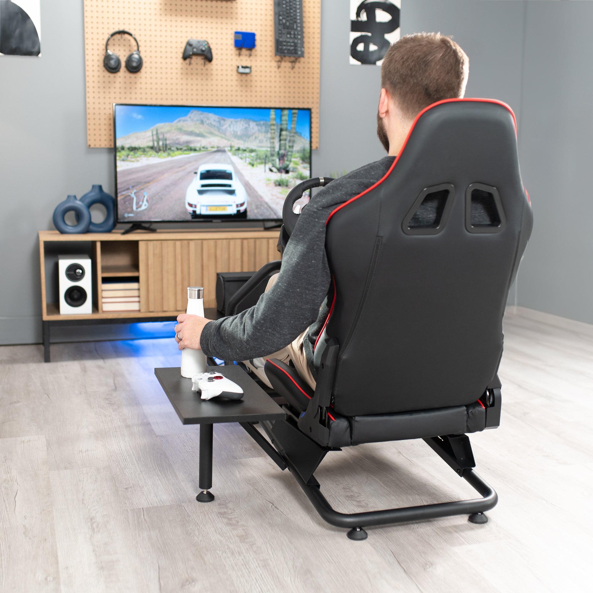 Racing simulator cockpit gaming chair with PC shelf and side shelf.