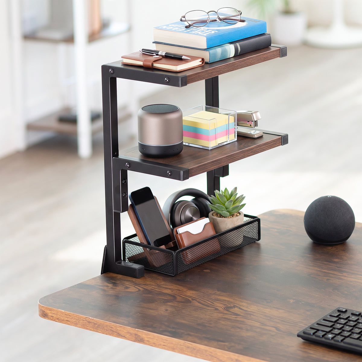 Vintage brown desk shelf clamped onto edge of desk in a home office space with accessories organized on the two shelves