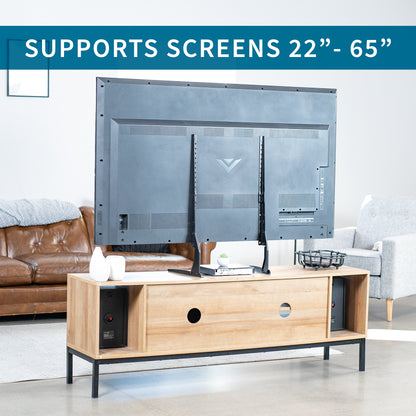 TV mounted on a steel stand in a living room setting with text indicating screen support.