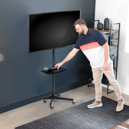 Mobile TV cart displays large screen on rolling stand for ergonomic viewing.