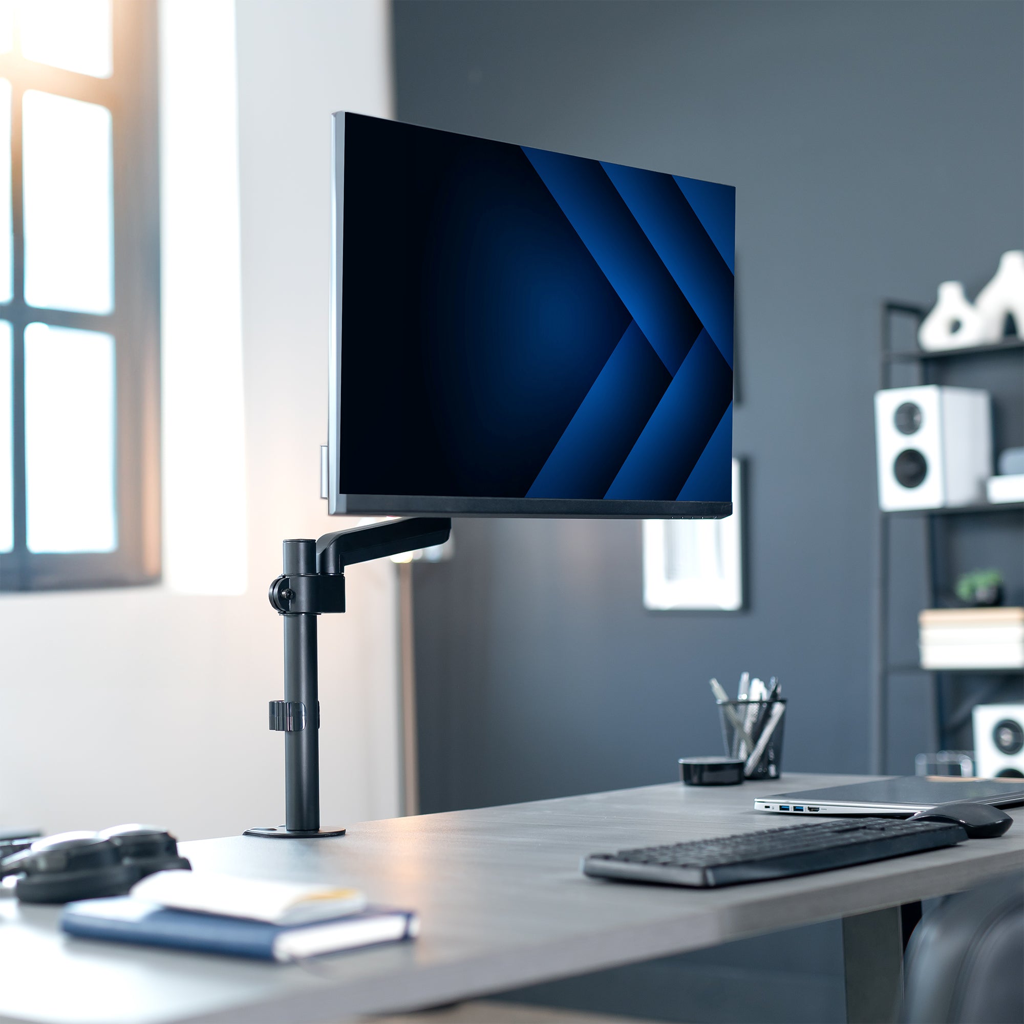Pneumatic single monitor mount in modern office setting