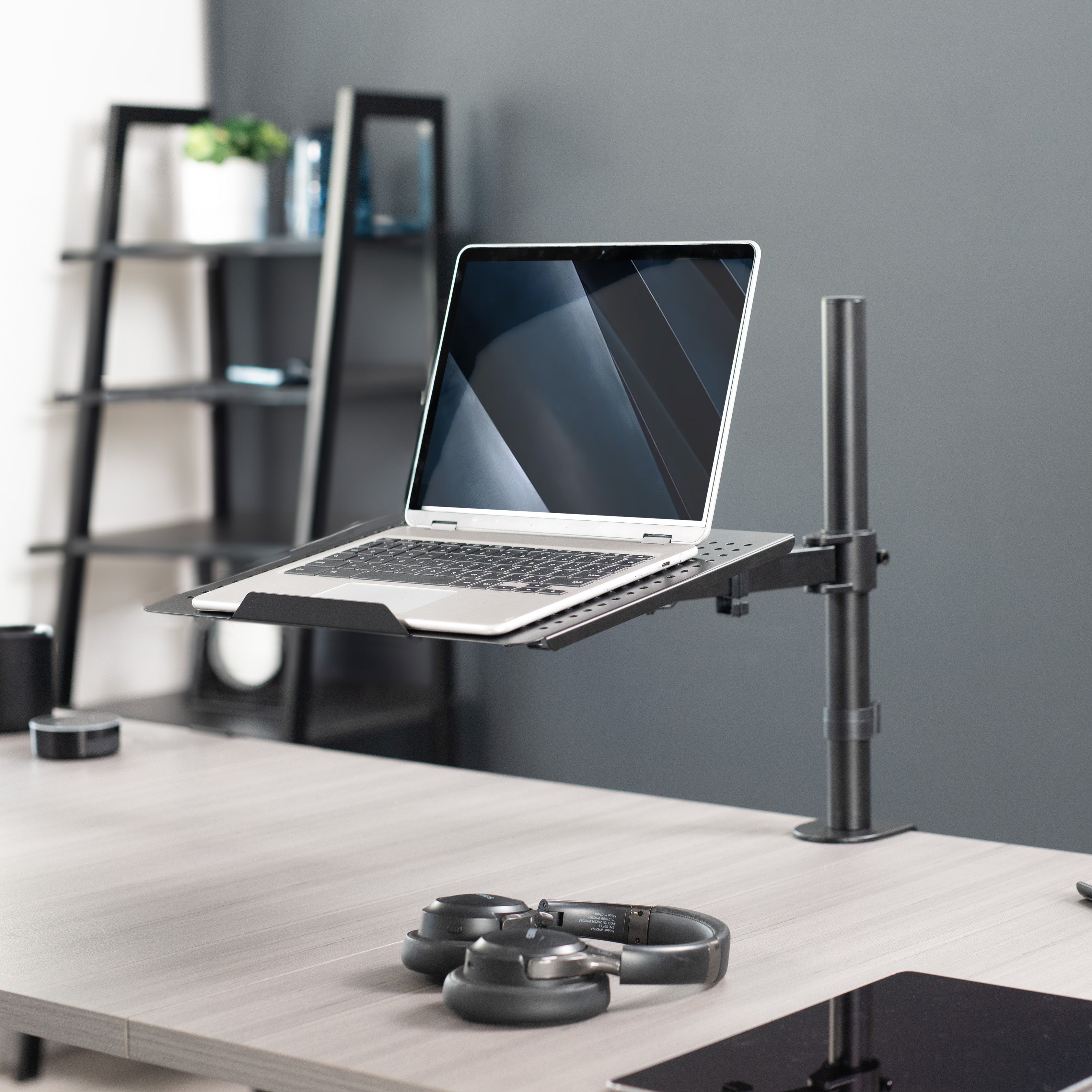 Height adjustable clamp-on laptop stand with ventilation and cable management.