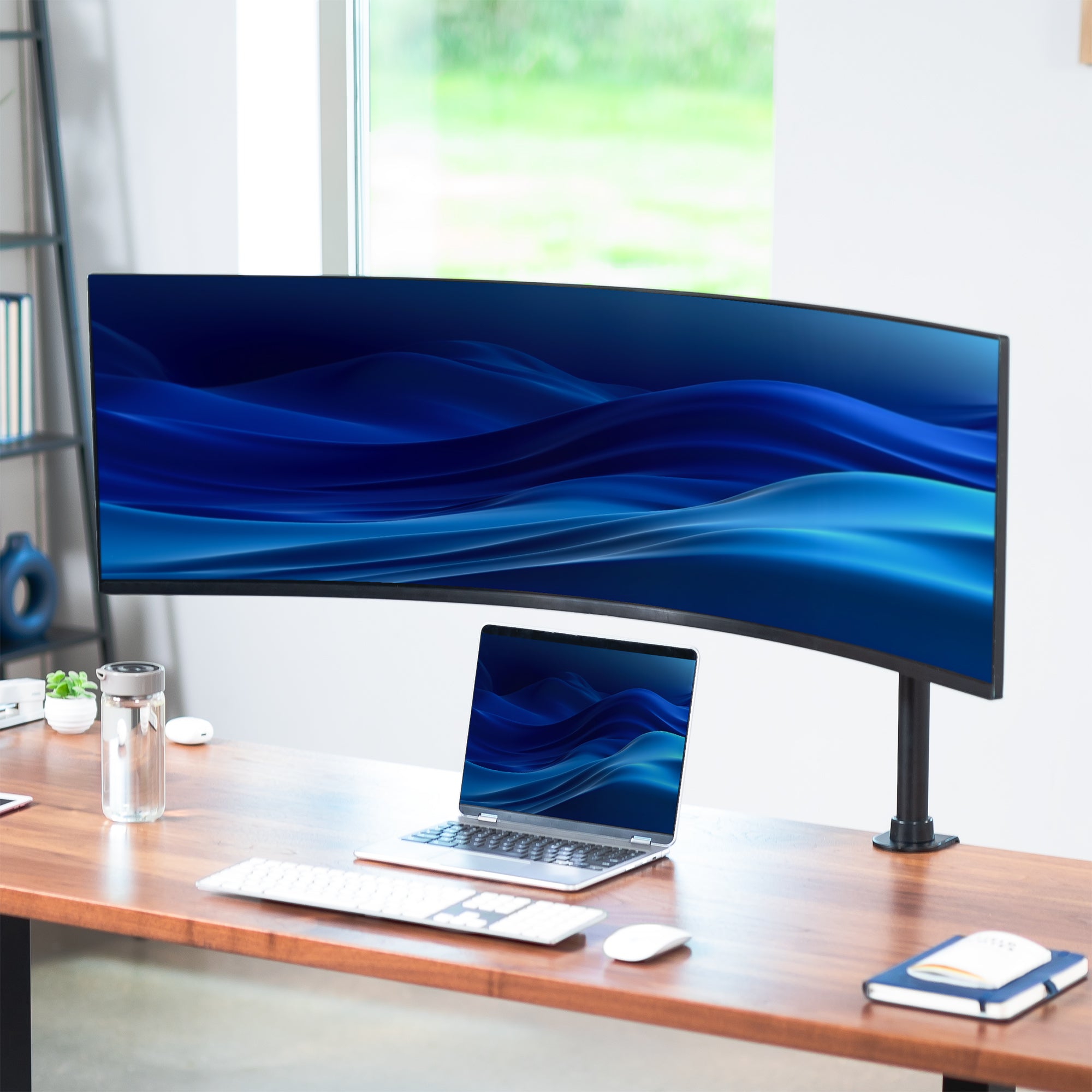 Single Ultrawide Monitor Desk Mount mounted to a walnut desk in home office.