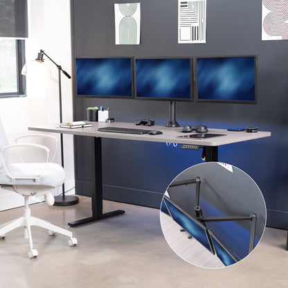 Modern office setup with a standing desk, computer monitors, and white chairs.