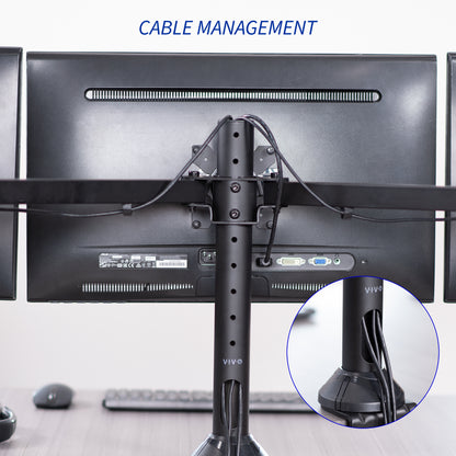 Computer monitors with cable management system on a desk