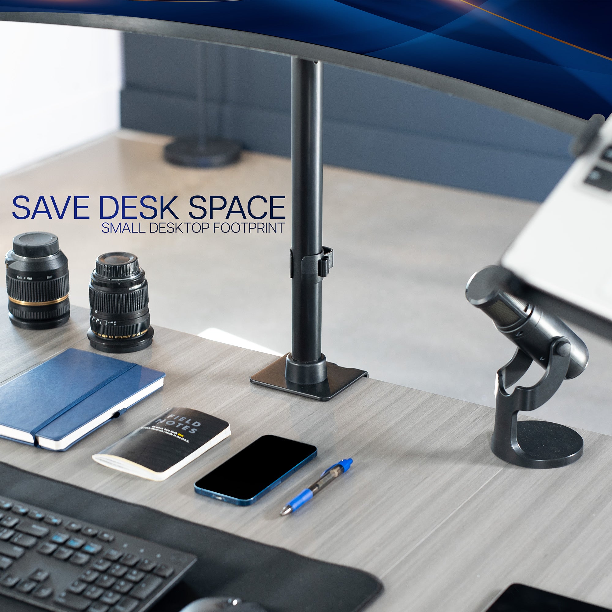 Desk setup with camera lenses, notebook, phone, and pen on a desk with text 'Save Desk Space'.