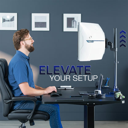 Man sitting at a desk with computer equipment, with 'Elevate Your Setup' text and monitor stand in the foreground.