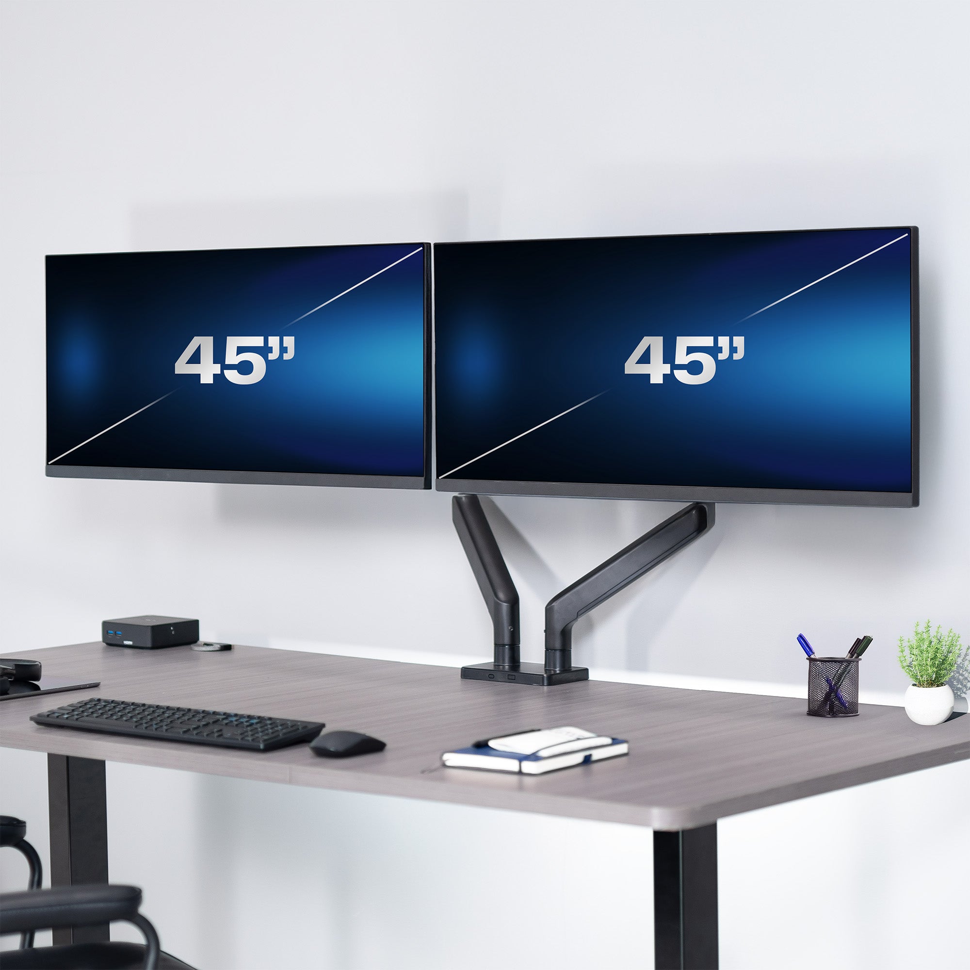 A dual monitor desk mount with pneumatic arms, capable of supporting ultrawide screens in an office setting. 