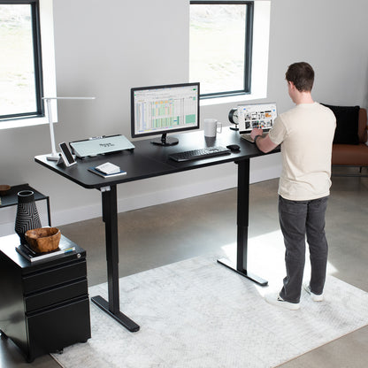 Wide surface sturdy sit or stand active workstation with adjustable height using 2 button control panel.