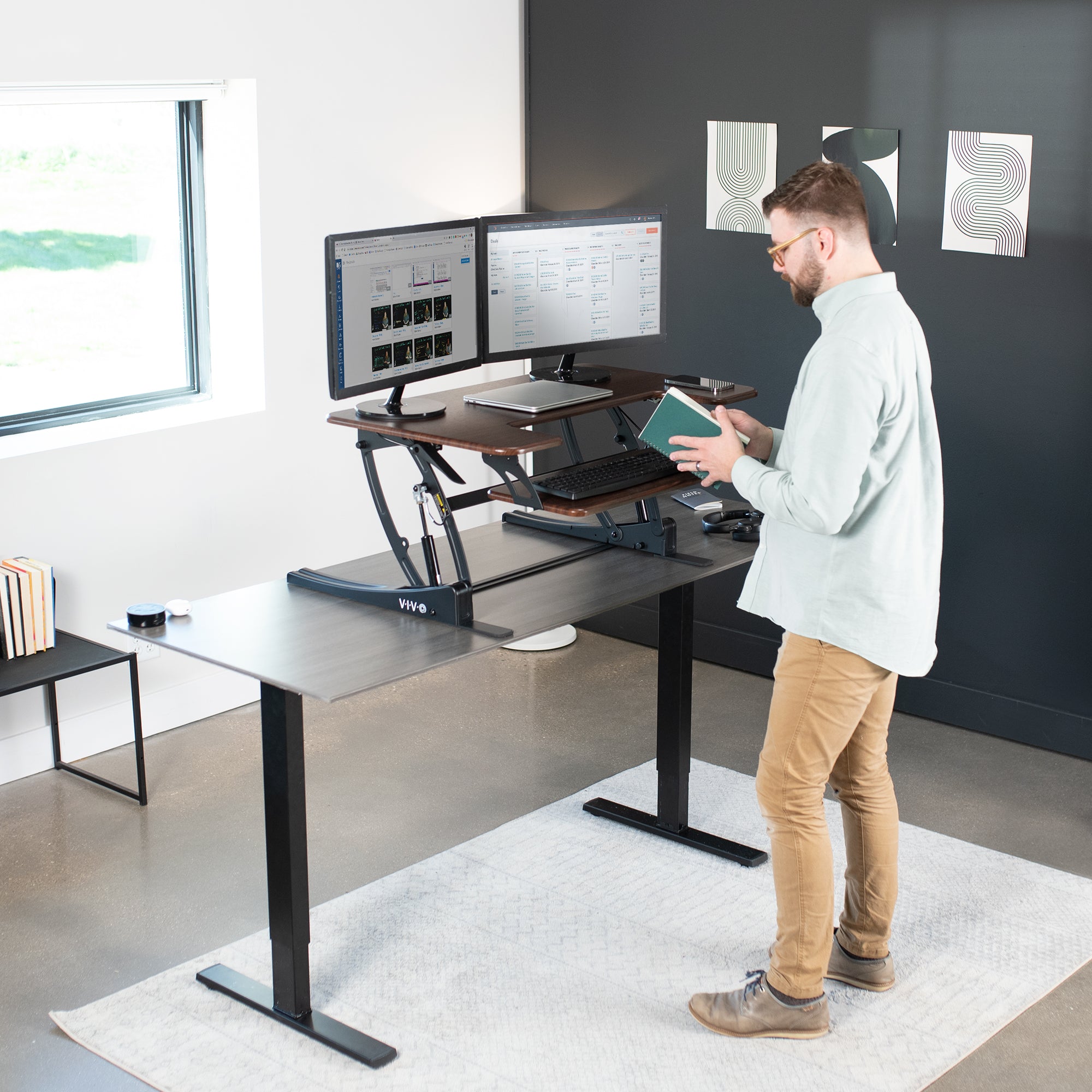 Heavy-duty height adjustable desk converter monitor riser with 2 tiers.