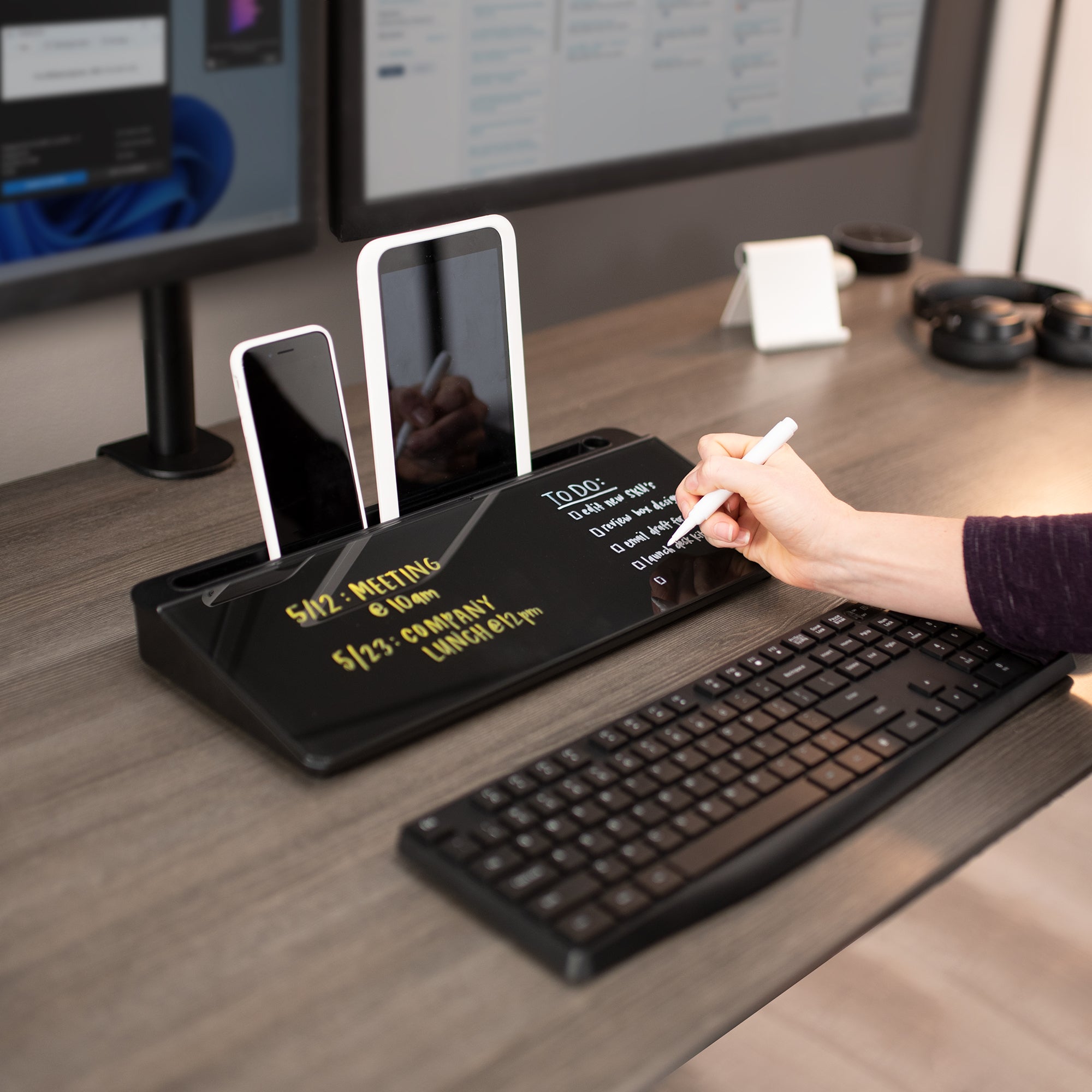 Convenient desktop whiteboard with storage drawers for organized workspace.