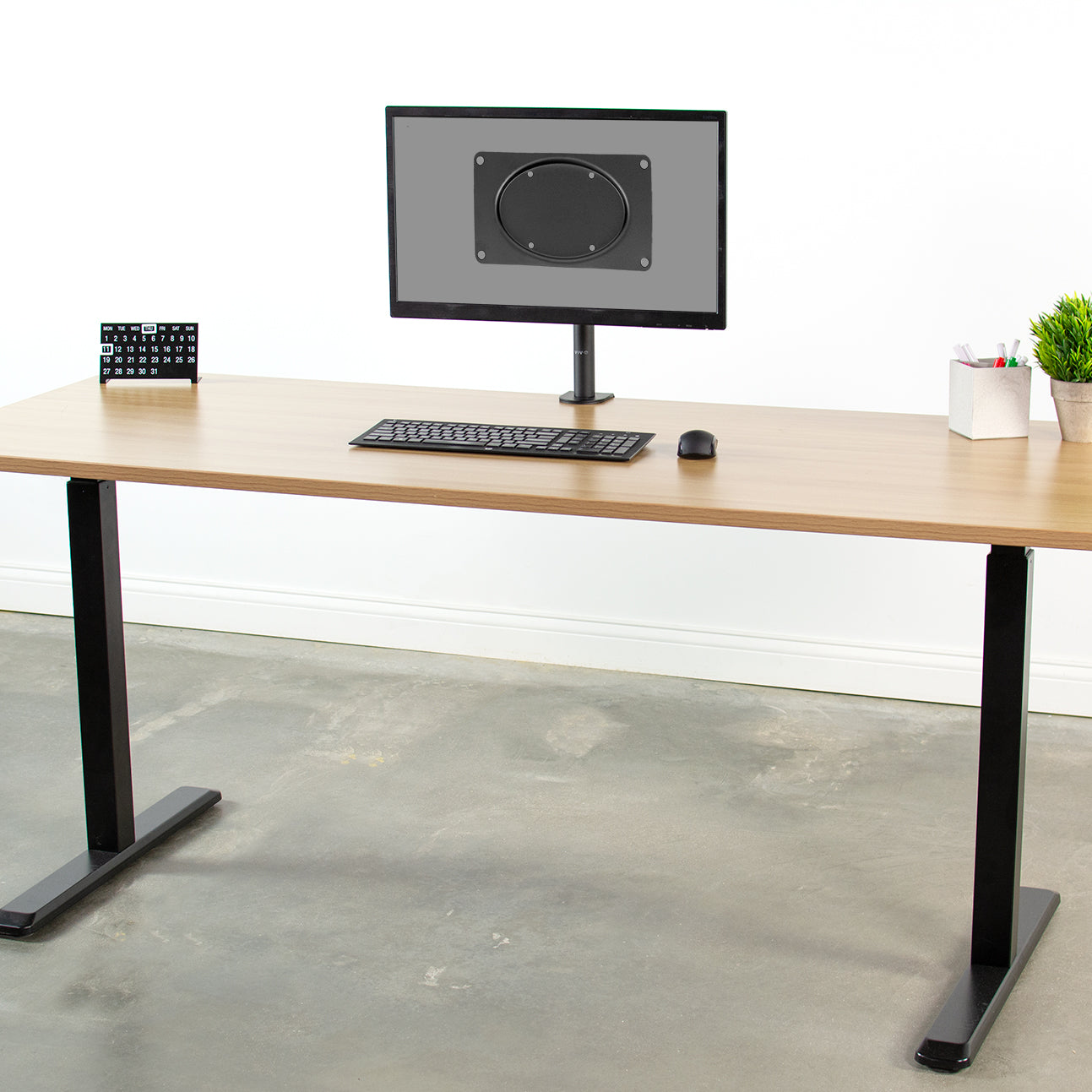 VESA monitor adapter on a screen in a modern workspace.