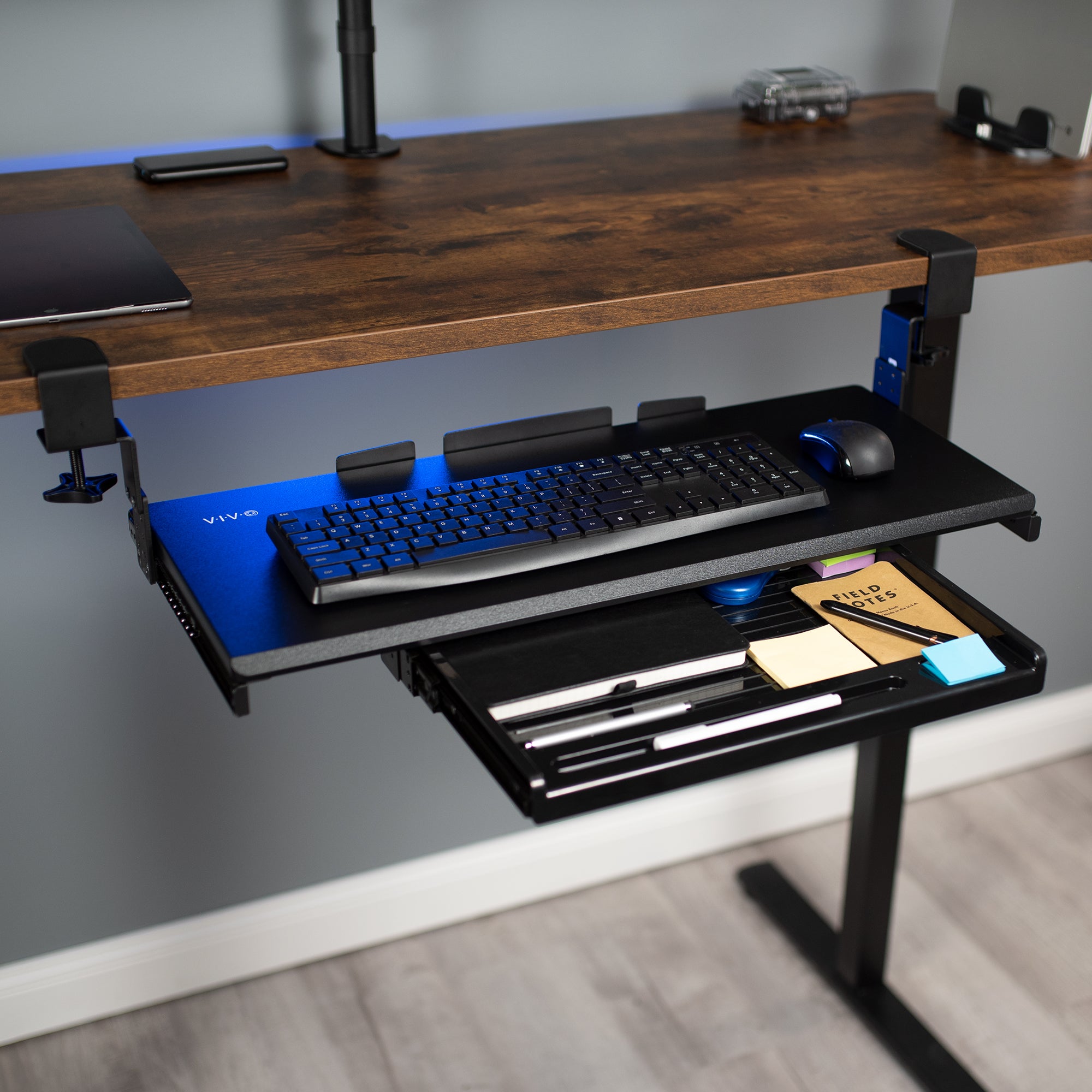 Clamp-on height adjustable convenient keyboard tray with pencil drawer for space efficient desk workstation.