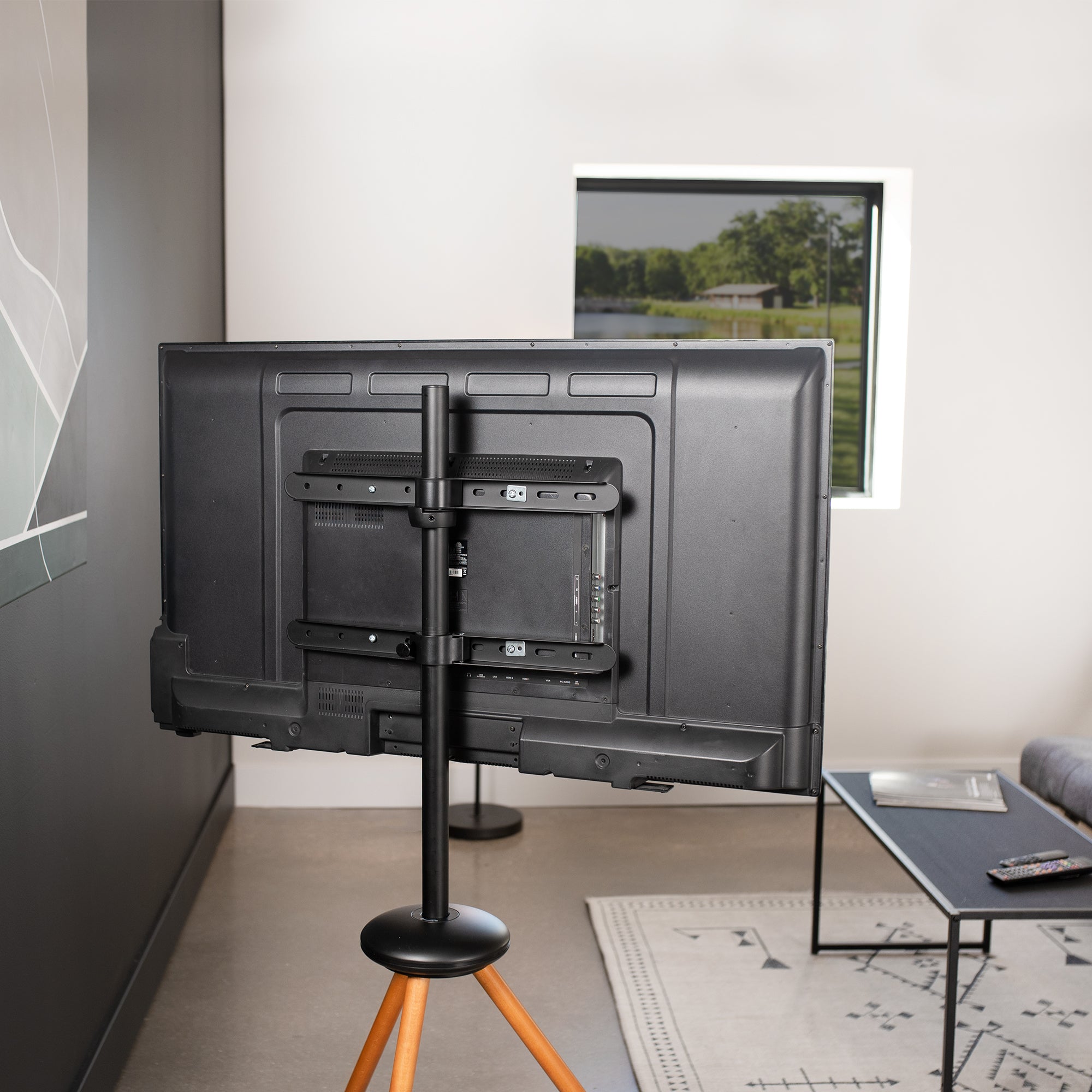 Dark walnut foldable easel studio TV stand supports 43” to 65” TV screens weighing up to 66 lbs. This collapsible tripod accommodates on-the-go presentations while also providing solid support for your screen.