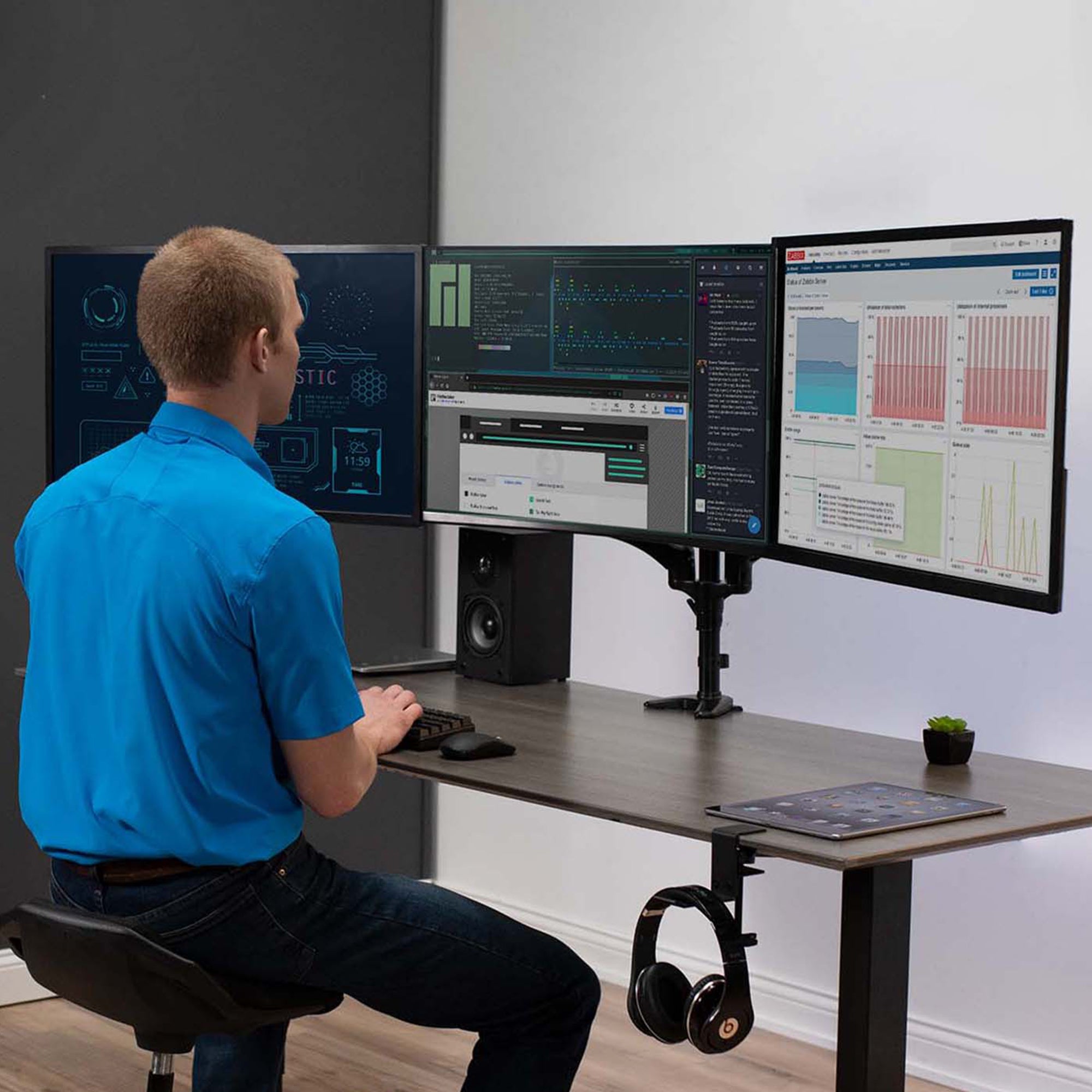 Triple monitor sturdy desk mount with adjustable pneumatic arms and integrated cord management.